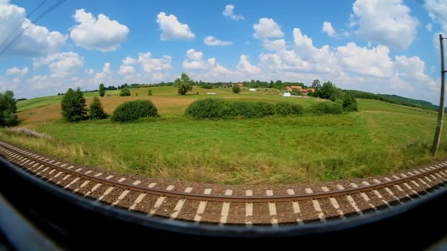 view from the window of a moving train on a sunny summer day. wide angle