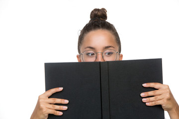 Close up portrait of a young woman student covering her face with book isolated over the white