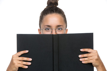 Close up portrait of a young woman student covering her face with book isolated over the white