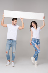 Happy summer couple with white board