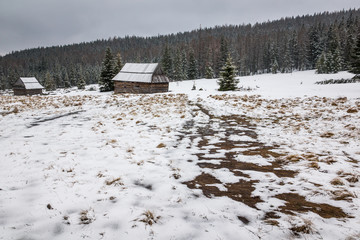 Wooden huts on the Kopieniec glade in Tatra mountains at winter, Malopolskie, Poland