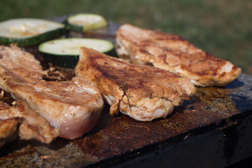 Grilling chicken breast and vegetables on the stone, hot meat dishes