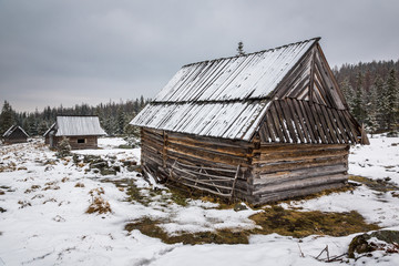 Wooden huts on the Kopieniec glade in Tatra mountains at winter, Malopolskie, Poland