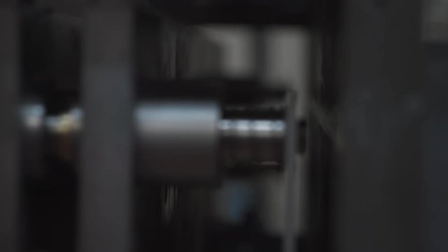 Machinery shop. Die cutting machine. Punching mechanism part moving. Environmentally friendly production from paper raw materials. Plant or factory background, indoor, closeup, panoram