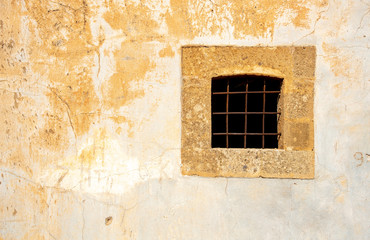 Metallic open window on a yellow grungy wall