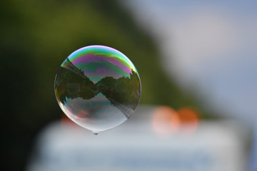 Colorful soap bulbs with reflections of a street scene on the christopher street day 2018 in Berlin-Germany.