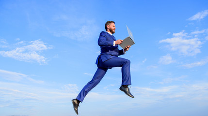 Fototapeta na wymiar Excellent internet provider raise up quality connection. Internet connection so fast. Boost speed online. Businessman laptop satisfied quality. Man with laptop jump or fly in air blue sky background
