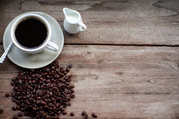 coffee cup and coffee bean on wood table