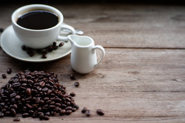 coffee  cup and coffee bean on old wood table
