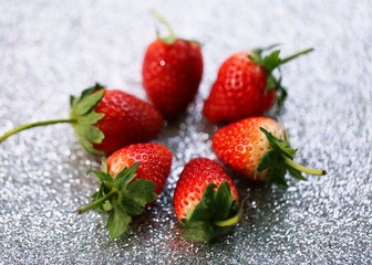 Fresh red strawberry closeup glitter blur background
