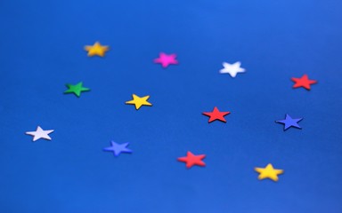 Flat lay of star decorations closeup on blue texture blur background