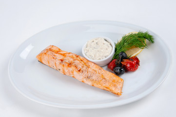 Salmon steak with sauce and lemon