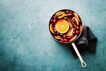 Mulled wine with fruits in saucepan