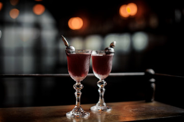 Two red delicious cocktails on the bar counter