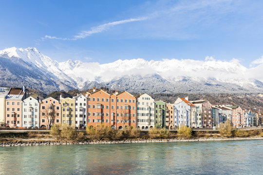 Austria, Innsbruck, row of houses in front of Nordkette Mountains with Inn River in the foreground
