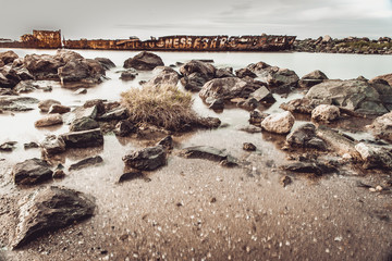 Fototapeta premium The wild sea beach with stones at sunrise. Big stones on the beach. Morning inflow of water. Nessebar. Bulgaria 