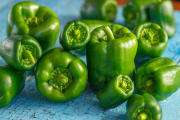 Green peppers on the blue wooden background