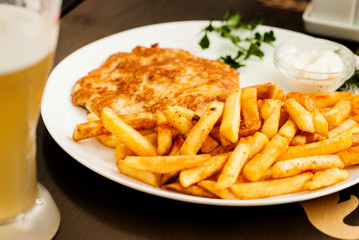 Vienna schnitzel and French fries. Traditional Austrian dish.