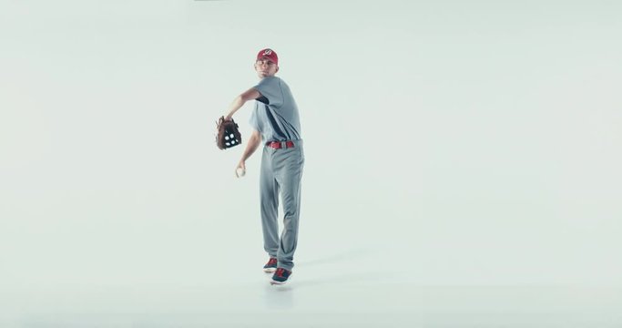 Caucasian professional baseball player pitcher throwing a ball towards camera isolated on white background. 4K UHD 60 FPS SLOW MOTION