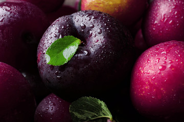 Ripe juicy plums as background