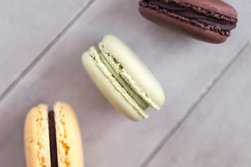 Colorful french macaroons on gray concrete background. Top view, copy space for text. Social media, blogging concept. 