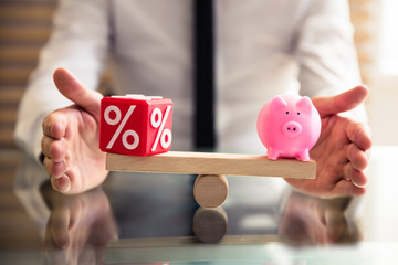 Hand Protecting Balance Between Percentage And Piggybank