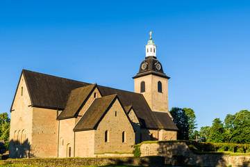 Fototapeta na wymiar Vreta abbey church in Sweden, on a sunny morning. The oldest parts of the building is from around year 1110.