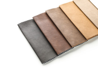 Leather samples of different colors for interior design on white background