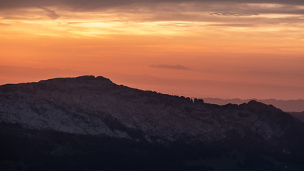 dramatic sunset behind mountain range, mountain silhouette swiss alps brienzer rothorn