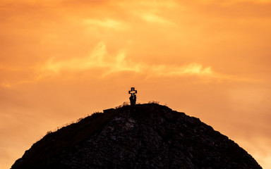 people on mountain summit peak with cross during sunset silhouette dramatic sunset brienzer rothorn switzerland