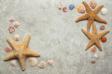 Flat lay composition with seashells on gray background. Beach objects
