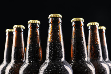 Many bottles of beer on dark background