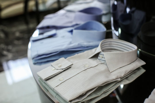 Classic men's shirts on shelf in boutique