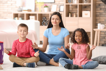 Young woman with little kids indoors. Child adoption