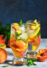 Ice tea with peach and lemon. Cold summer drink.