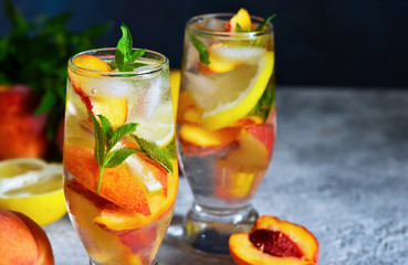 Fototapeta na wymiar Ice tea with peach and lemon. Cold summer drink.
