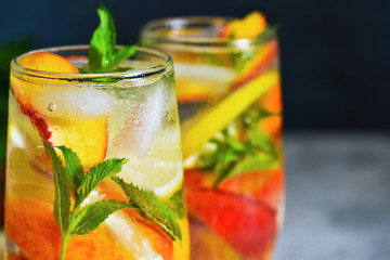 Ice tea with peach and lemon. Cold summer drink.