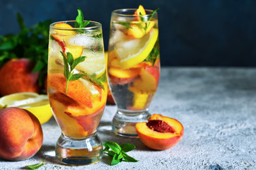 Ice tea with peach and lemon. Cold summer drink.