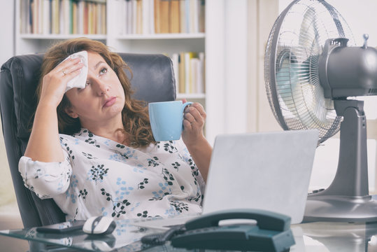 Woman Suffers From Heat In The Office Or At Home