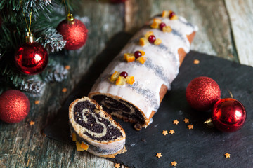 Poppy seed christmas glazed roll with candied fruits and cranberries
