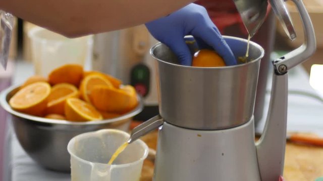 Squeezing of orange juice at the healthy food and beverage bar