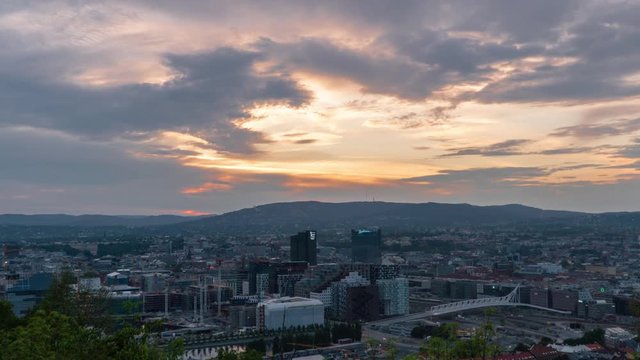 Wide Late Afternoon timelapse of Oslo in Norway on a cloudy day at the start of sunset