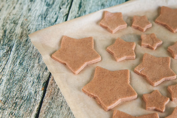 Preparing Christmas gingerbread cookies on a baking paper