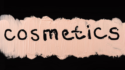 Texture of liquid foundation. Close up of a make up liquid cream foundation on black background. Cosmetics text