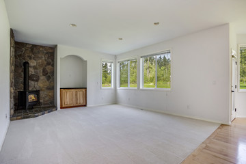 White family room with stone fireplace.