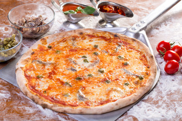 close up of delicious pizzawith anchovies and capers