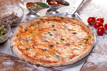 close up of delicious pizzawith anchovies and capers