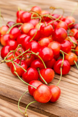 Pile of cherries on wooden background. Close up.