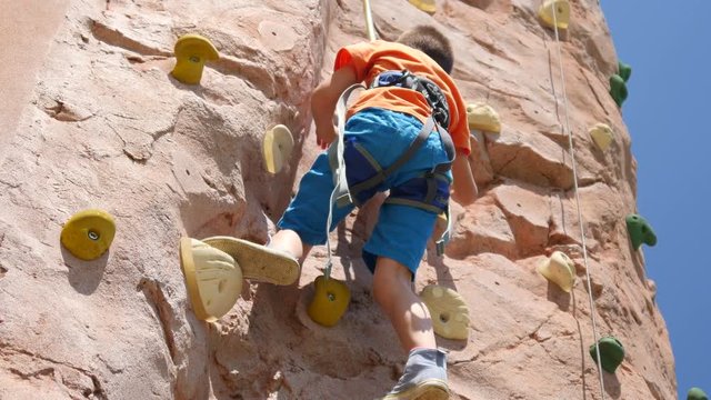 Healthy lifestyle family festival - children kids climbing the wall gym in park