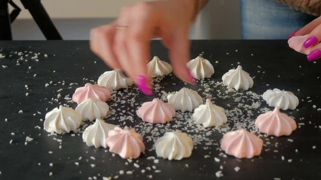 backstage photography. food photoshoot preparation. creative workspace setting. photo stylist lays out meringues.